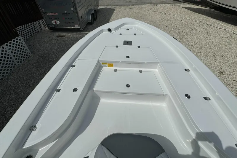 Slide: The Image of 2025 NauticStar 224 Bay boat deck with storage compartments. - 3