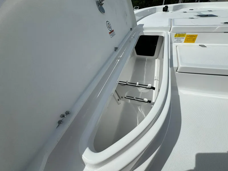 Slide: The Image of 2025 NauticStar 224 Bay boat storage compartment open. - 5