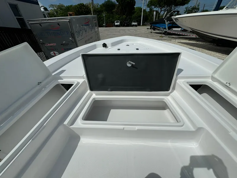 Slide: The Image of 2025 NauticStar 224 Bay boat with open storage compartments. - 6