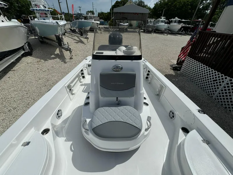 Slide: The Image of 2025 NauticStar 224 Bay boat interior at a dealership. - 8