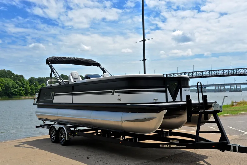Slide: The Image of 2023 Viaggio Diamante 26 U Platinum pontoon boat on trailer by a lake. - 16