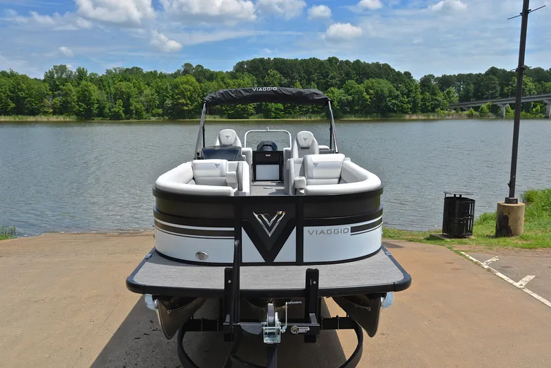 Slide: The Image of 2023 Viaggio Diamante 26 U Platinum pontoon boat at a lakeside dock. - 17