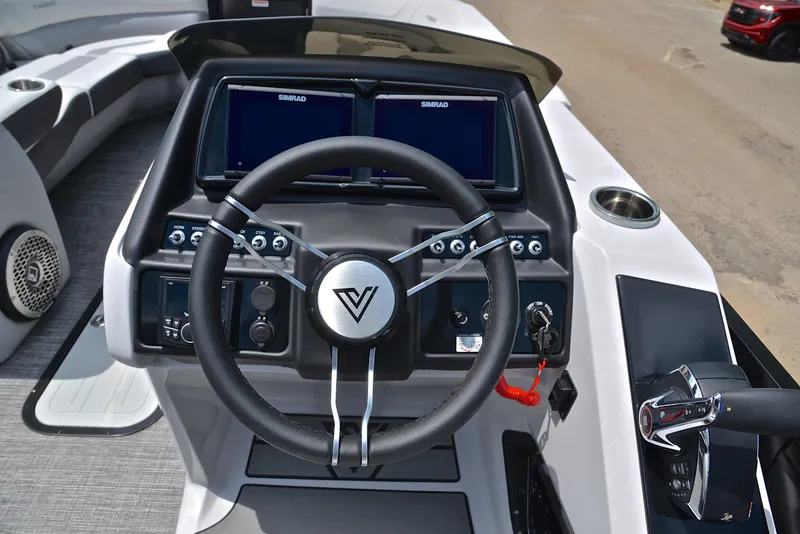 Slide: The Image of 2023 Viaggio Diamante 26 U Platinum boat dashboard with steering wheel and dual Simrad displays. - 27