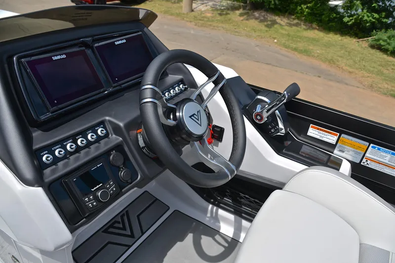 Slide: The Image of 2023 Viaggio Diamante 26 U Platinum boat dashboard with steering wheel and control panel. - 28
