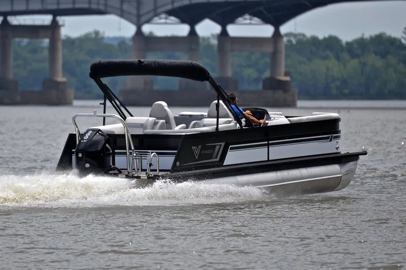Slide: The Image of 2023 Viaggio Diamante 26 U Platinum pontoon boat cruising on a river near a bridge. - 5
