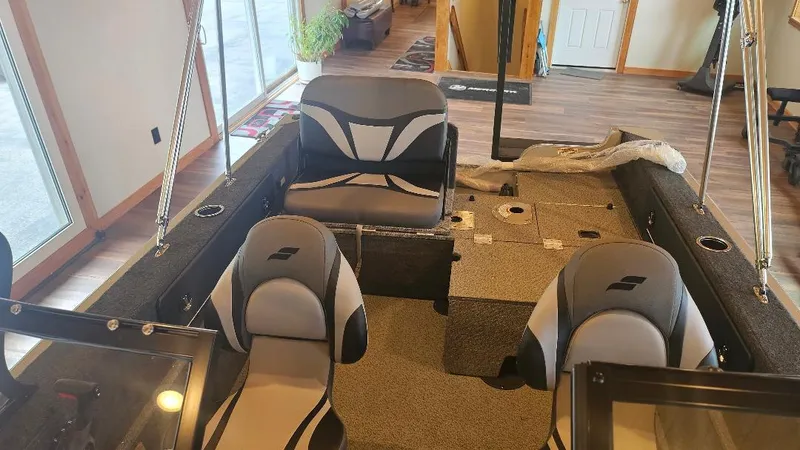 Slide: The Image of Interior of 2025 Starcraft FUSION 16 DC boat with modern seating and carpeted flooring. - 1