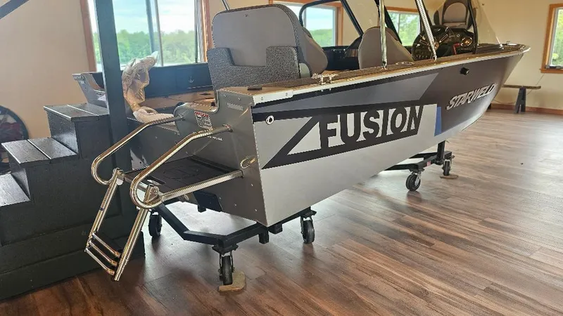 Slide: The Image of Starcraft FUSION 16 DC 2025 boat displayed indoors on a wooden floor. - 3