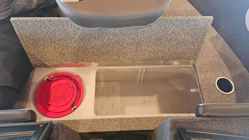 Slide: The Image of Starcraft FUSION 16 DC 2025 boat storage compartment with red safety equipment. - 5