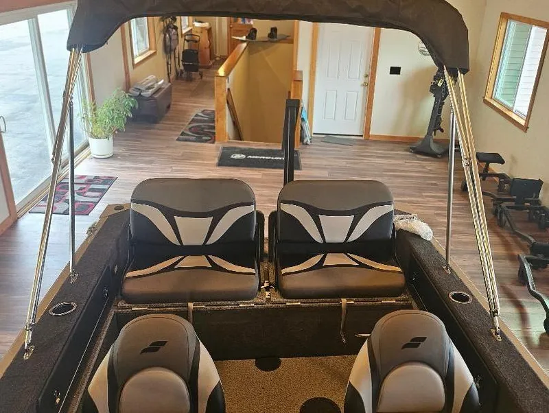 Slide: The Image of 2025 Starcraft FUSION 16 DC boat interior with modern seating in a showroom. - 7