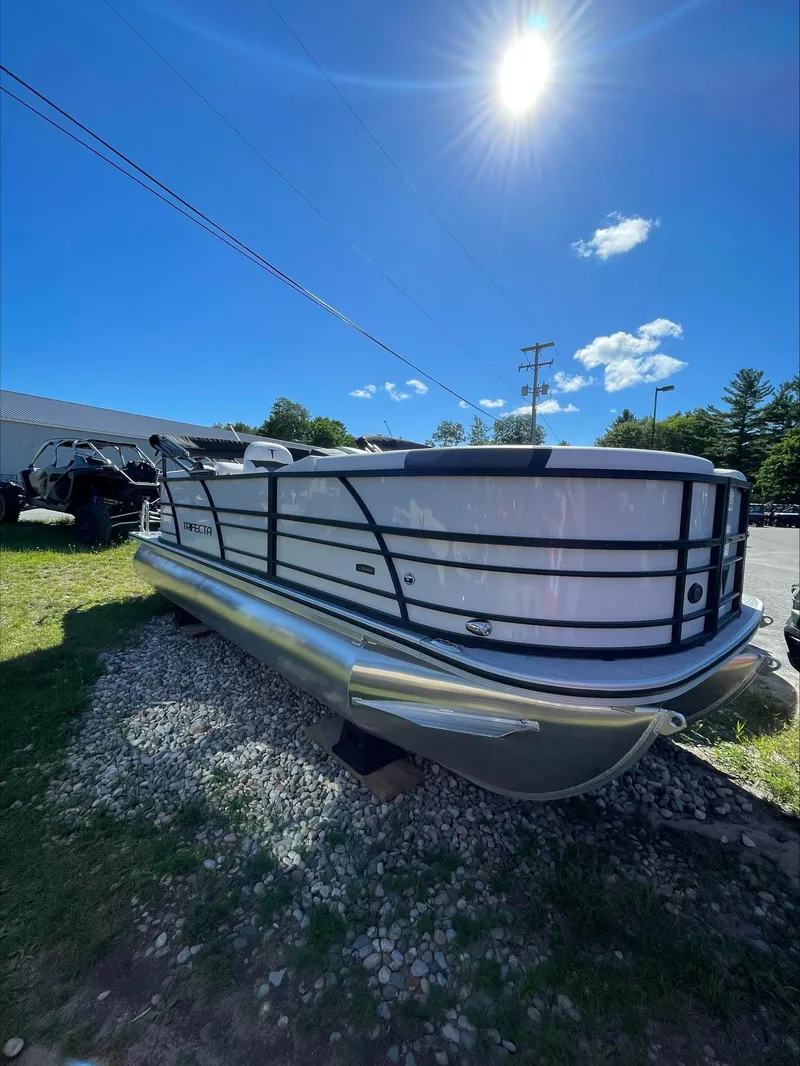 The Image of 2024 Trifecta 22RFCS pontoon boat under bright sun. - 0