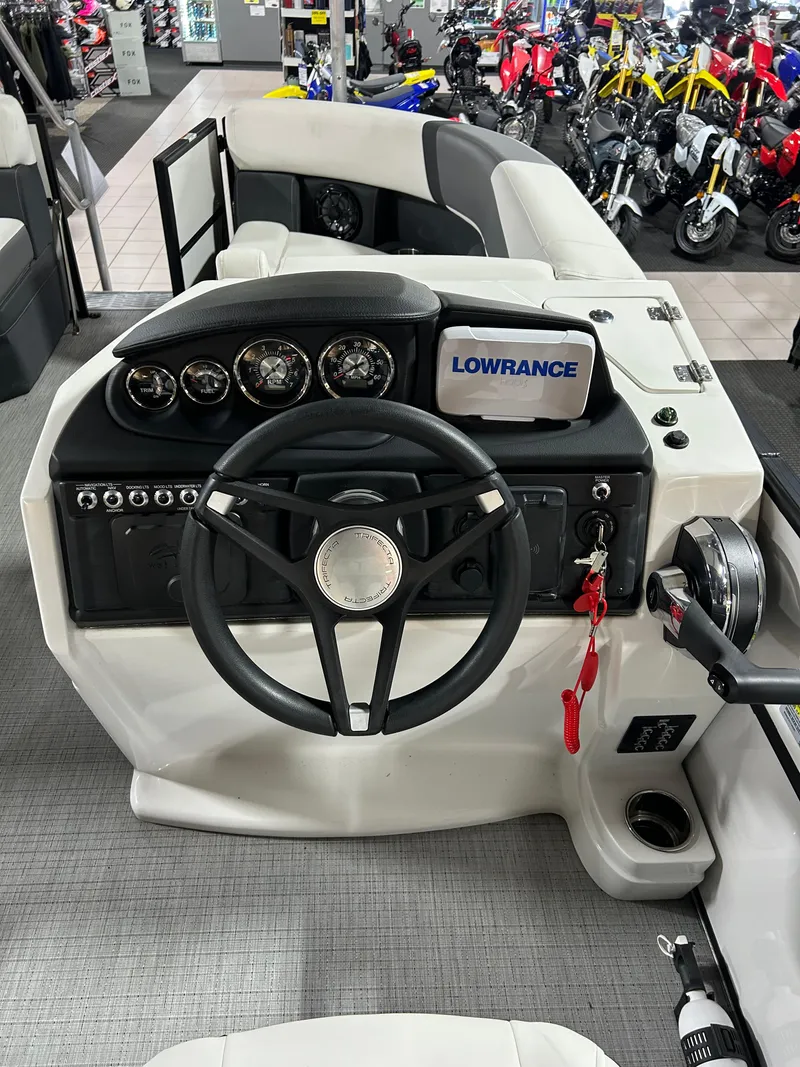 Slide: The Image of 2024 Trifecta 22RFCS boat dashboard with steering wheel and Lowrance display. - 5