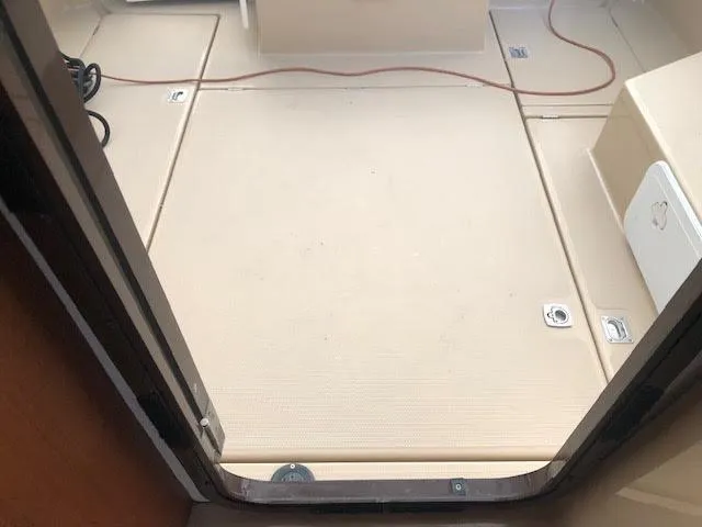 Slide: The Image of 2016 Ranger Tugs R-27 boat with beige cushioned seating on deck. - 14