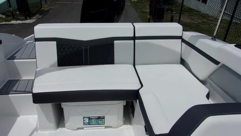 Slide: The Image of 2025 Monterey M 205 boat seating area with white and black cushioned seats. - 8