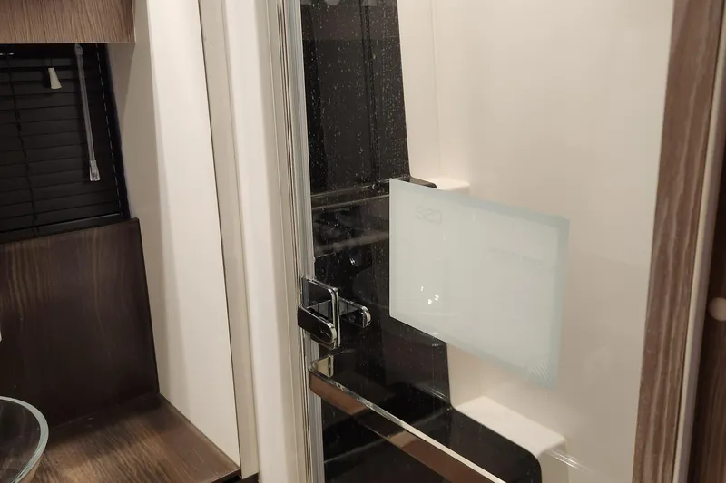 Slide: The Image of Interior of 2019 Azimut S6 yacht featuring a modern bathroom with glass shower door. - 18