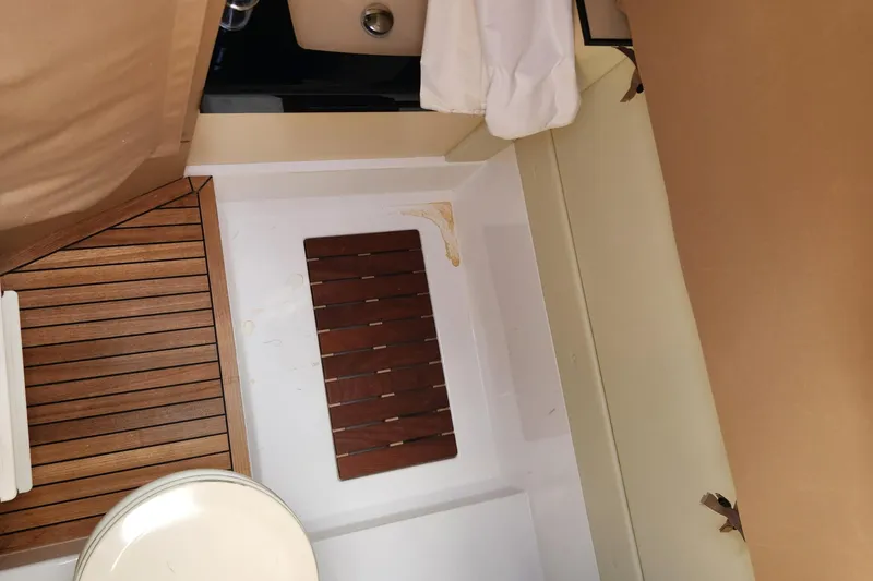 Slide: The Image of Interior of 2019 Azimut S6 yacht featuring wooden flooring and compact design. - 23