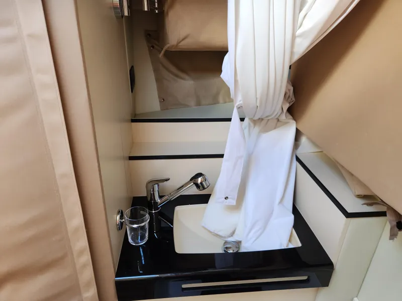 Slide: The Image of 2019 Azimut S6 yacht bathroom sink with modern fixtures and white curtain. - 24