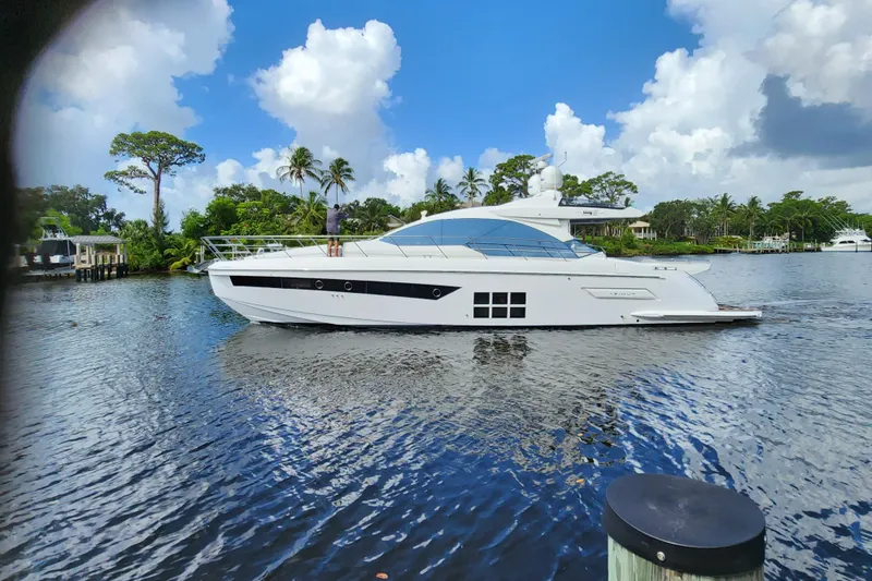 Slide: The Image of 2019 Azimut S6 yacht on a serene waterway with lush greenery. - 3