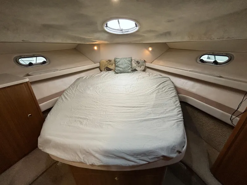 Slide: The Image of 2000 Bayliner 3788 Command Bridge Motoryacht bedroom with bed and porthole windows. - 21