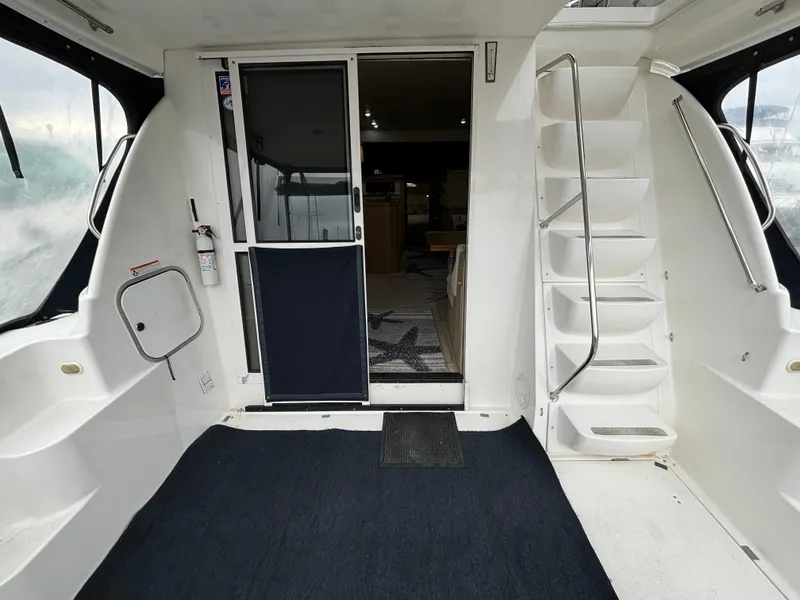 Slide: The Image of 2000 Bayliner 3788 Command Bridge Motoryacht interior with stairs and sliding door. - 6