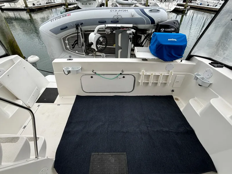 Slide: The Image of Bayliner 3788 Command Bridge Motoryacht 2000 aft deck with dinghy and Tohatsu outboard motor. - 7