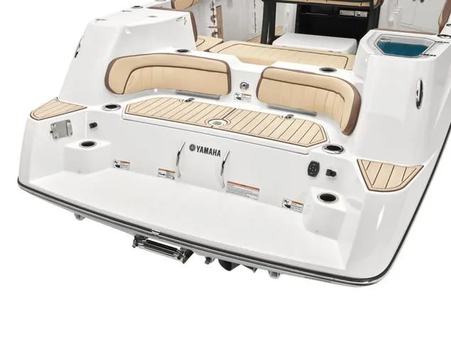 Slide: The Image of 2024 Yamaha Boats 255 FSH Sport H, rear deck view with seating and storage. - 10