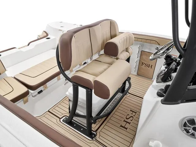 Slide: The Image of 2024 Yamaha Boats 255 FSH Sport H interior with beige seating and FSH logo on deck. - 20
