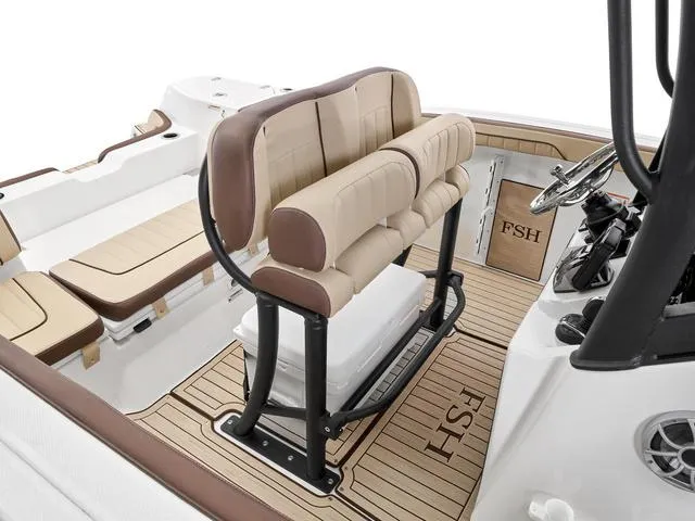 Slide: The Image of 2024 Yamaha Boats 255 FSH Sport H interior with cushioned seating and steering console. - 24