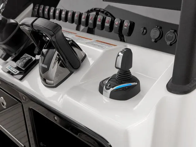 Slide: The Image of 2024 Yamaha Boats 255 FSH Sport H control panel with joystick and throttle. - 25