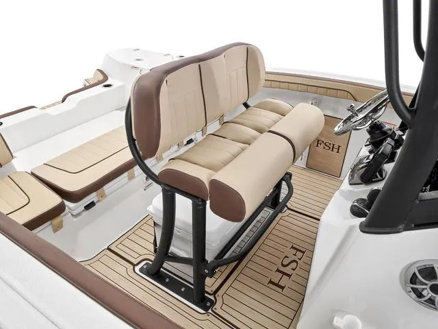 Slide: The Image of 2024 Yamaha Boats 255 FSH Sport H interior with beige seating and teak flooring. - 4