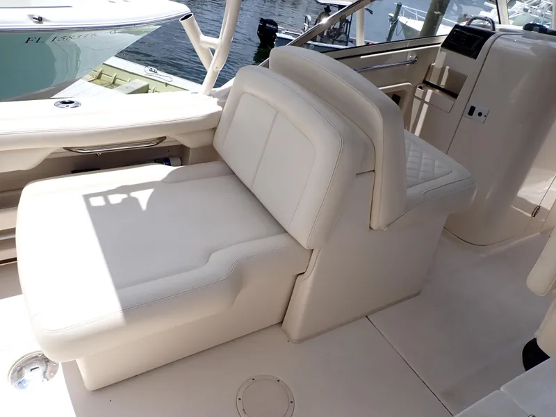Slide: The Image of 2019 Grady-White Freedom 275 boat interior with white cushioned seating. - 14