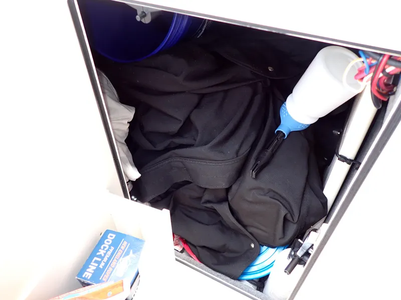 Slide: The Image of Storage compartment of a 2019 Grady-White Freedom 275 boat with various items. - 28