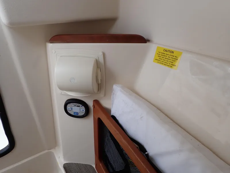 Slide: The Image of Interior detail of 2019 Grady-White Freedom 275 boat with caution label and storage compartment. - 34