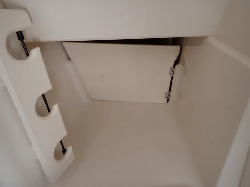 Slide: The Image of 2019 Grady-White Freedom 275 storage compartment with rod holders. - 37