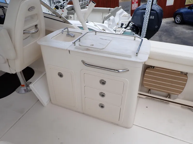 Slide: The Image of 2019 Grady-White Freedom 275 boat interior with sink and storage drawers. - 43