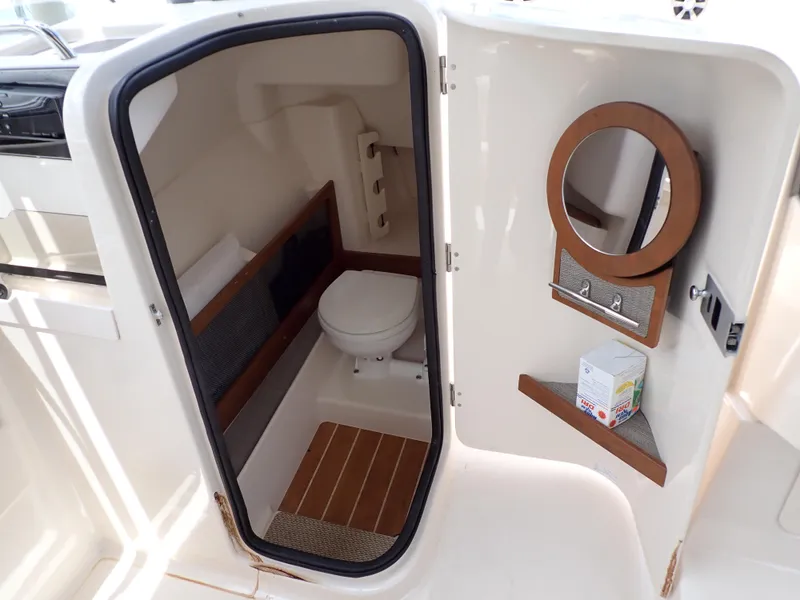 Slide: The Image of 2019 Grady-White Freedom 275 boat interior bathroom with toilet and mirror. - 8