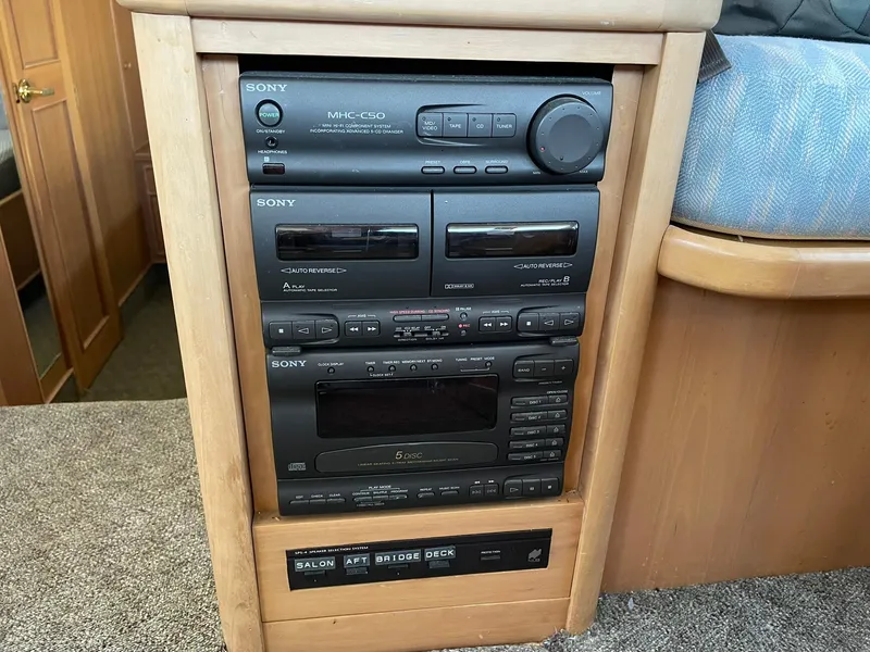 Slide: The Image of 1994 Queenship Motor Yacht audio system with Sony stereo components in wooden cabinet. - 10