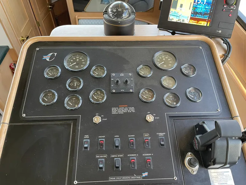 Slide: The Image of Control panel of a 1994 Queenship Motor Yacht with gauges and navigation equipment. - 15