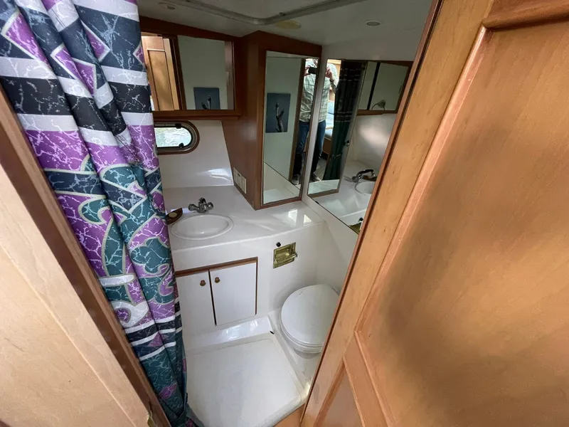 Slide: The Image of Bathroom interior of a 1994 Queenship Motor Yacht with shower, sink, and toilet. - 20