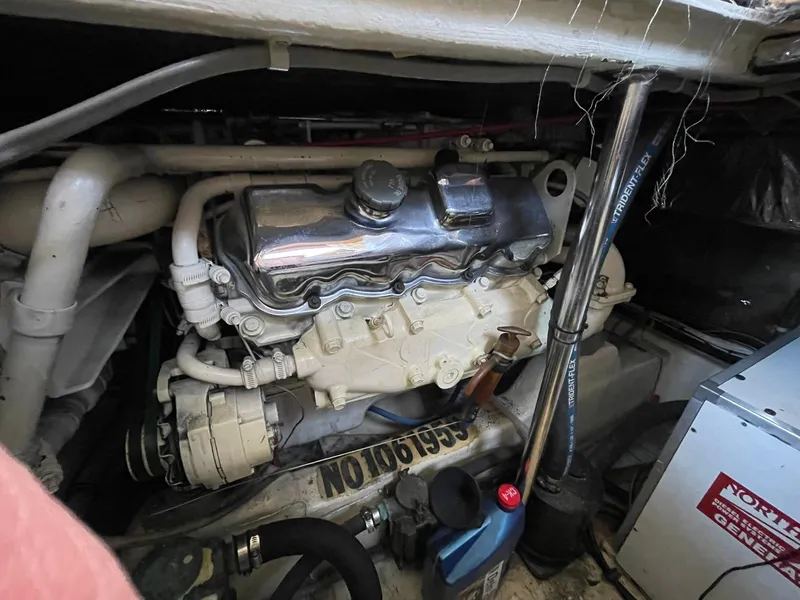 Slide: The Image of Engine room of a 1994 Queenship Motor Yacht, showcasing mechanical components and equipment. - 28