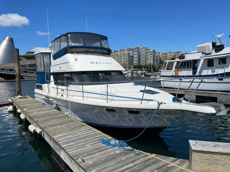 Slide: The Image of 1994 Queenship motor yacht docked at marina under clear blue sky. - 30