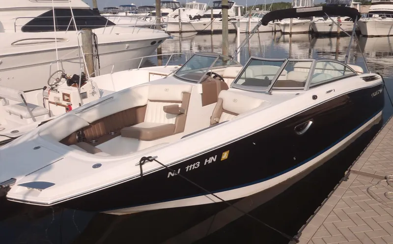 The Image of 2013 Cobalt 26SD boat docked at marina, featuring sleek design and spacious seating. - 0