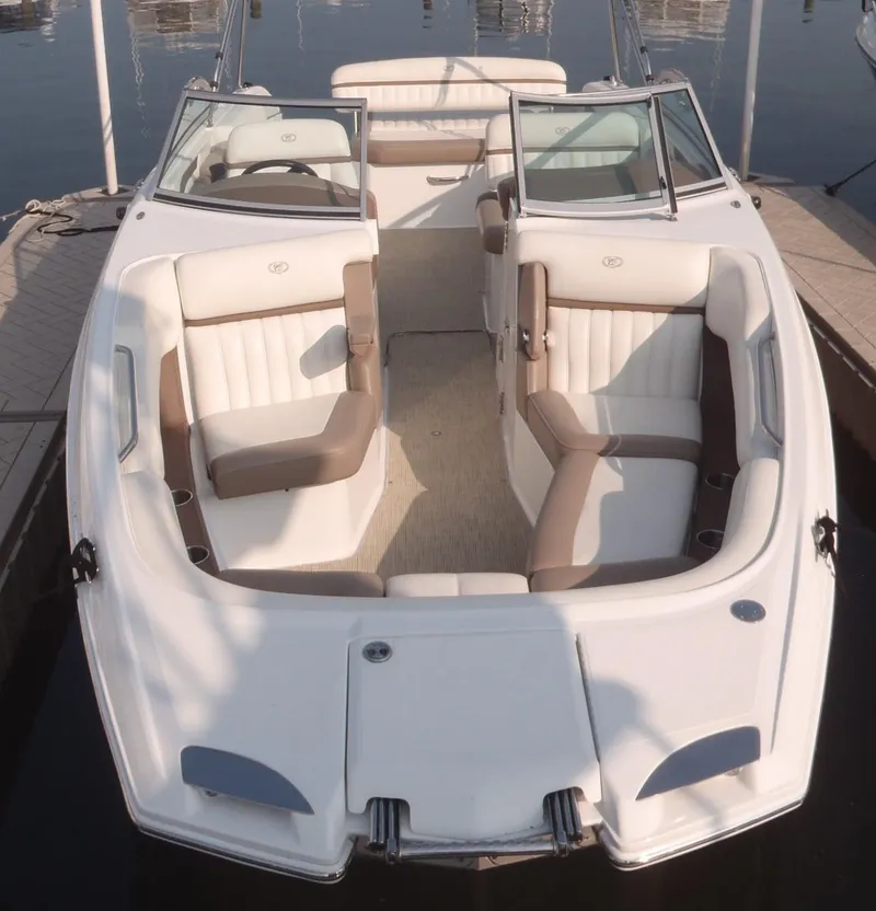 Slide: The Image of 2013 Cobalt 26SD boat with spacious seating, docked at a marina. - 15