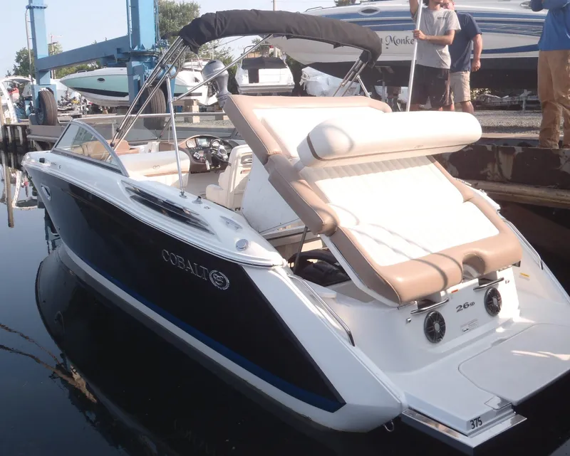 Slide: The Image of 2013 Cobalt 26SD boat docked, featuring sleek design and comfortable seating. - 5