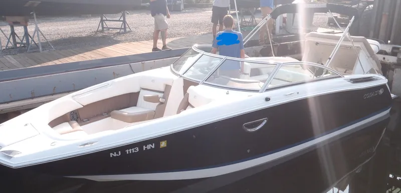 Slide: The Image of 2013 Cobalt 26SD boat docked, featuring sleek design and spacious seating. - 6