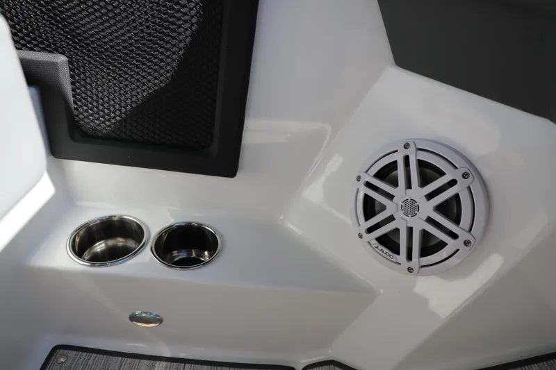 Slide: The Image of 2024 Cobalt R4 boat interior with speaker, cup holders, and storage net. - 16