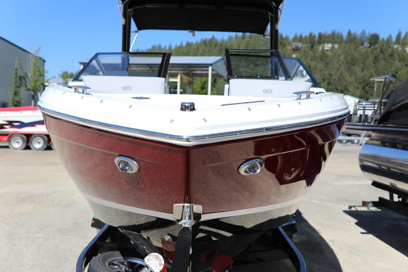 Slide: The Image of 2024 Cobalt R4 boat with sleek red hull and modern design, parked outdoors. - 3