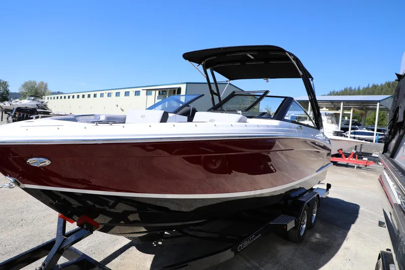 Slide: The Image of 2024 Cobalt R4 boat with sleek design on a trailer, parked outdoors. - 4