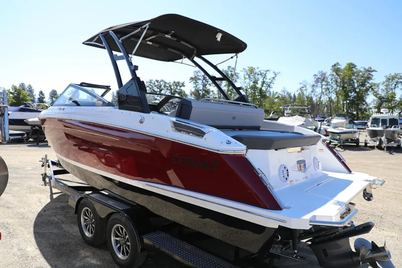 Slide: The Image of 2024 Cobalt R4 boat on trailer, red and white design, parked outdoors. - 5