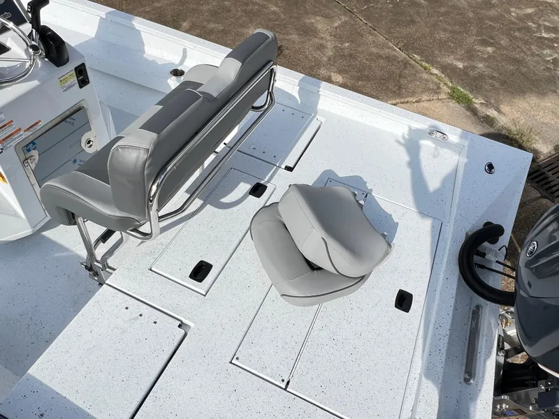 Slide: The Image of 2025 Xpress H22B HYPER-LIFT BAY boat interior with gray seating and storage compartments. - 10