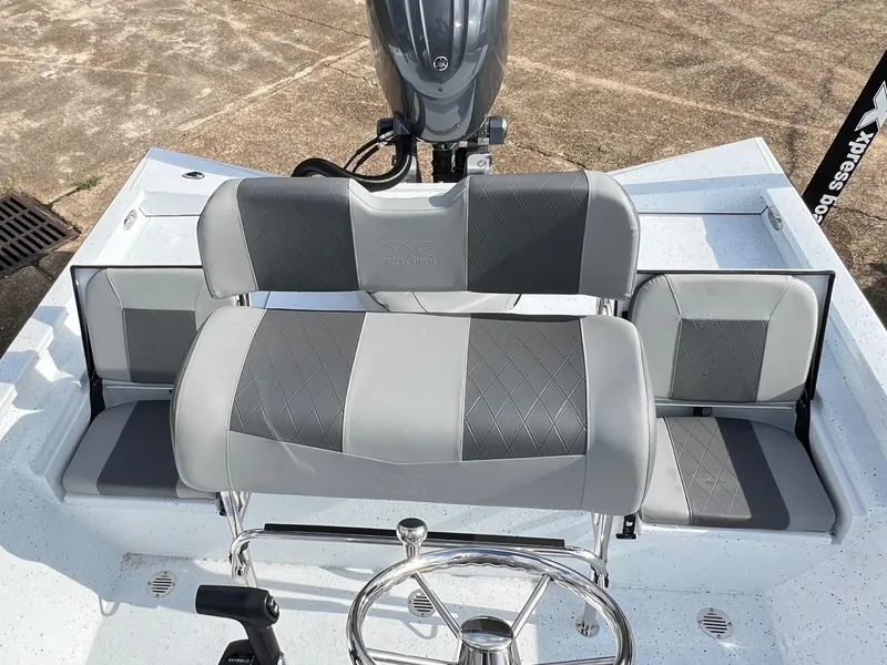 Slide: The Image of 2025 Xpress H22B HYPER-LIFT BAY boat interior with gray seating and steering wheel. - 7